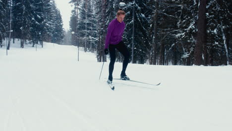 Young-adult-Caucasian-female-athlete-practicing-cross-country-skiing-on-a-scenic-forest-trail.-4K-UHD-60-FPS-SLO-MO